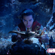 Mena Massoud finds a lamp in Disney’s Aladdin.